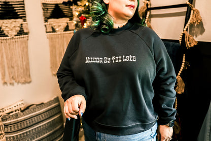 model wearing our crewneck by a Christmas tree. 