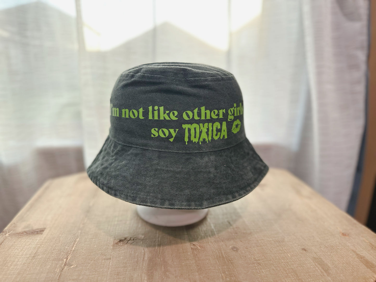 Denim Bucket Hat With Saying I'm Not Like Other Girls Soy Toxica" with stay text and lips. 