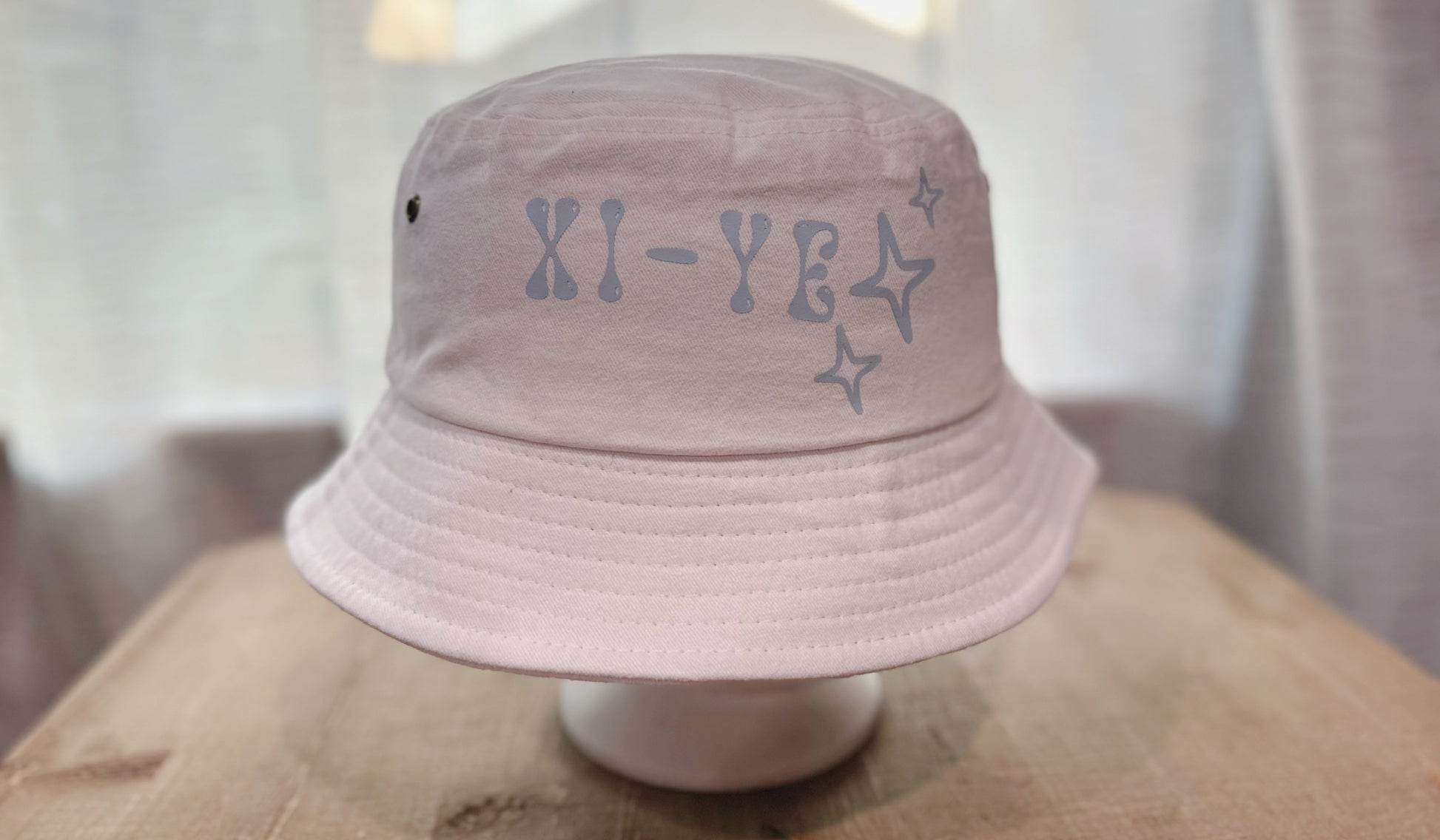 Xi-Ye Branding In Light Blue On White Bucket Hat. 