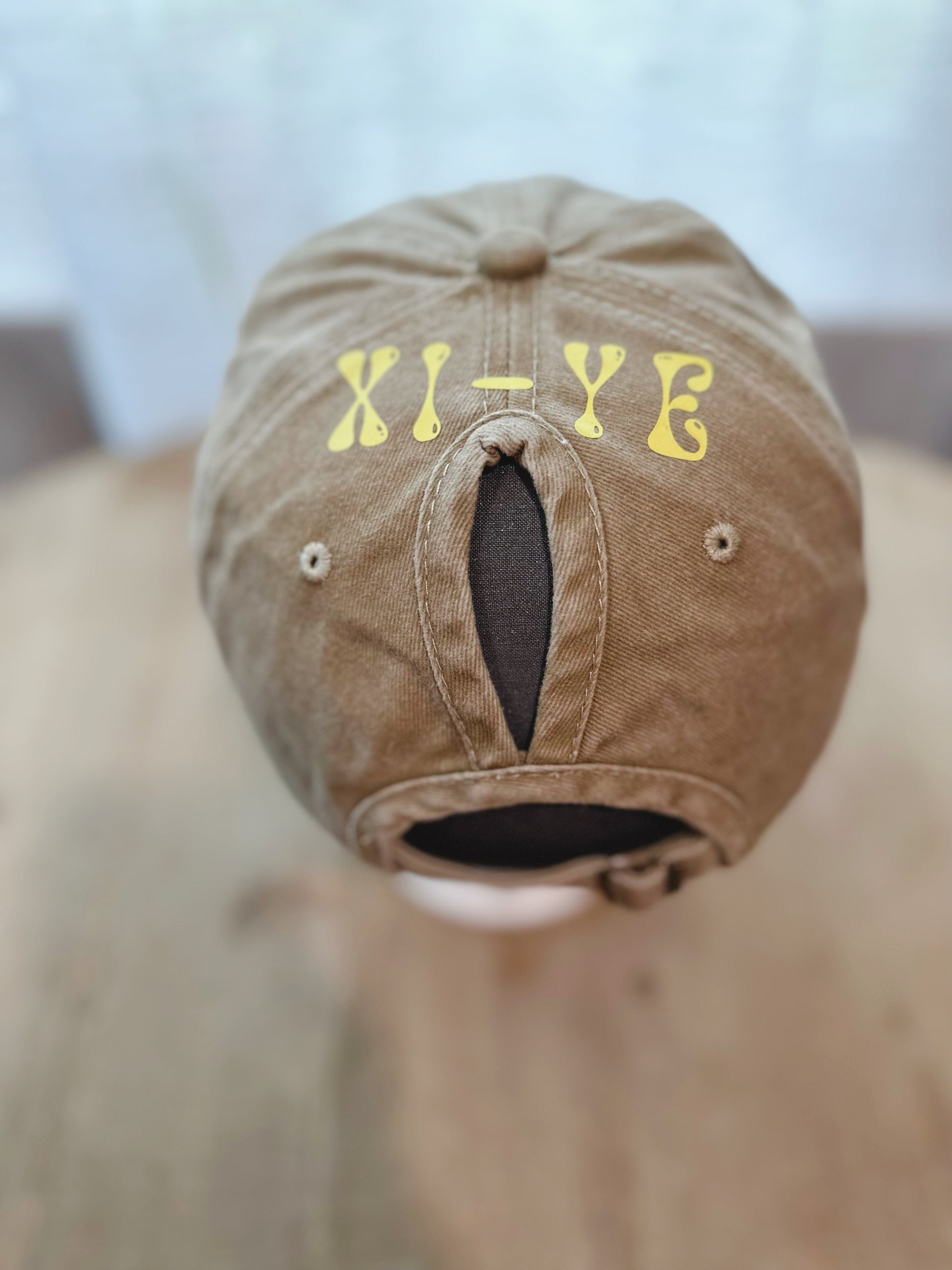 Tan Denim Hay With Yellow Branding Xi-Ye. 