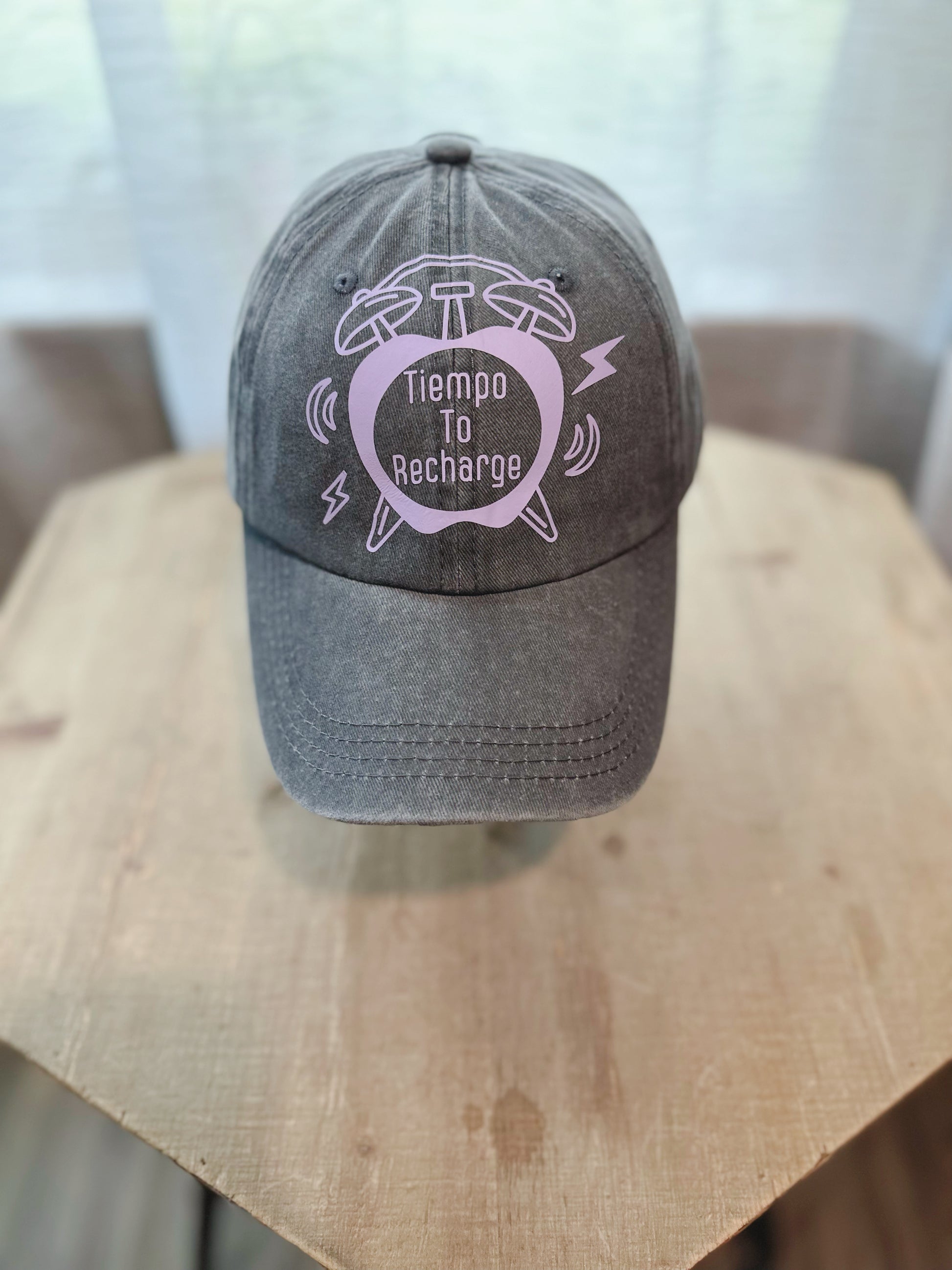 Denim Gray Dad Hat With Lilac Lettering Saying " Tiempo To Recharge" Inside A Clock.  