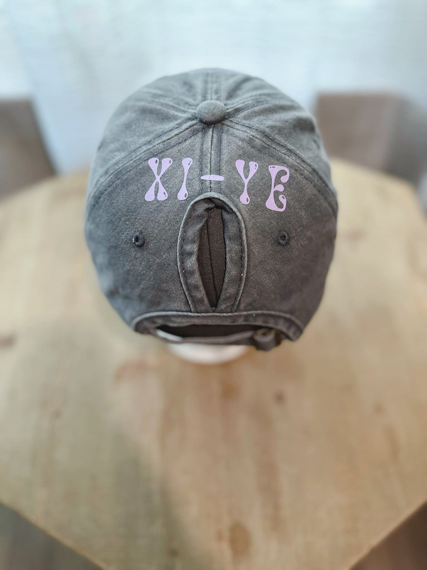 Dark Grey Denim Hat with Xi-Ye Branding In Lilac. 