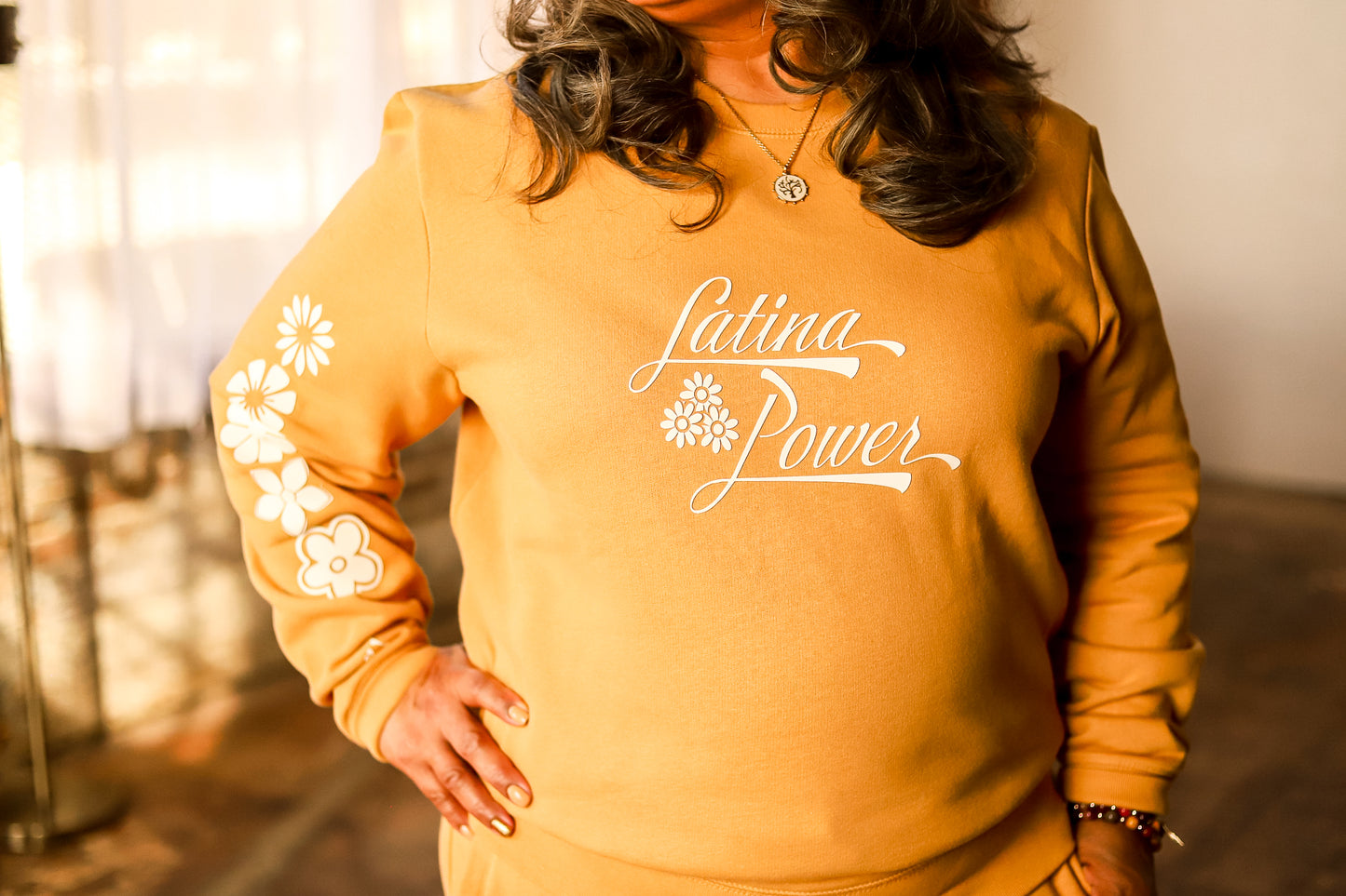 Camel yellow crewneck with white flowers and "Latina Power' saying.